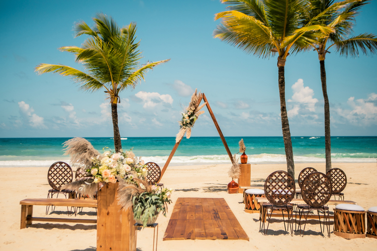 Beachfront destination wedding ceremony at Hard Rock Vallarta with ocean view and floral arch