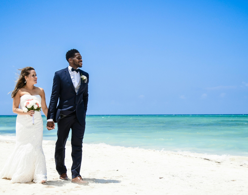 how to travel with your wedding dress, traveling with a wedding dress, destination wedding wedding dress tips, how to pack a wedding dress for flying, carrying on a wedding dress airplane, wedding dress travel tips, destination wedding planning tips, wedding dress on airplane, flying with a wedding gown, how to keep a wedding dress wrinkle free while traveling, travel garment bag for wedding dress, destination wedding bride tips, beach wedding dress travel, wedding dress packing hacks, international travel with wedding dress, TSA wedding dress tips, best garment bag for wedding dress travel, wedding dress carry on rules, destination wedding checklist bride, how to transport a wedding dress safely, wrinkle release for wedding dress travel, airport tips for brides, wedding dress steaming at resort, all inclusive destination wedding tips, Mexico destination wedding tips, Caribbean destination wedding planning, destination wedding expert advice, wedding travel essentials bride, bridal travel tips, wedding dress preparation for travel, stress free destination wedding planning, destination wedding bride guide, luxury destination wedding tips, Destinations by Amy