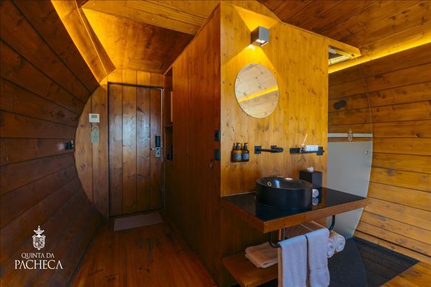 Modern bathroom vanity inside a luxury wine barrel suite at Quinta da Pacheca