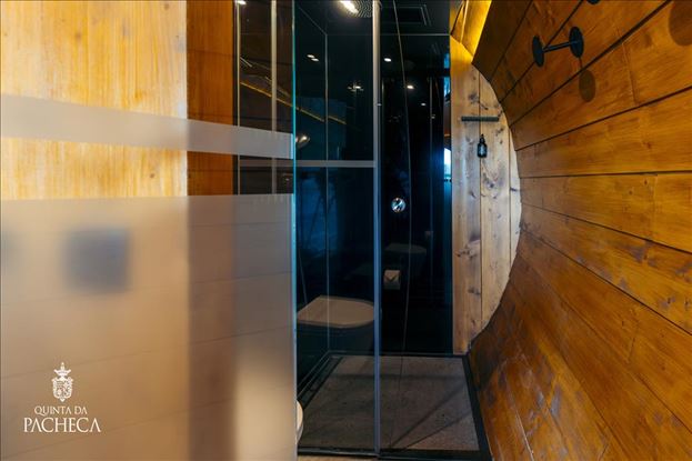 Contemporary glass shower inside the wooden wine barrel accommodations at Quinta da Pacheca