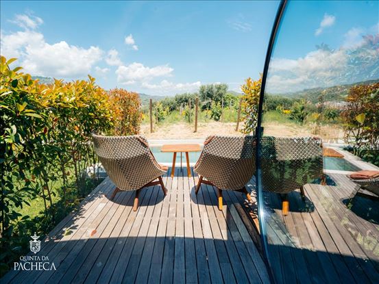 Private wooden terrace with chairs overlooking the vineyards at Quinta da Pacheca